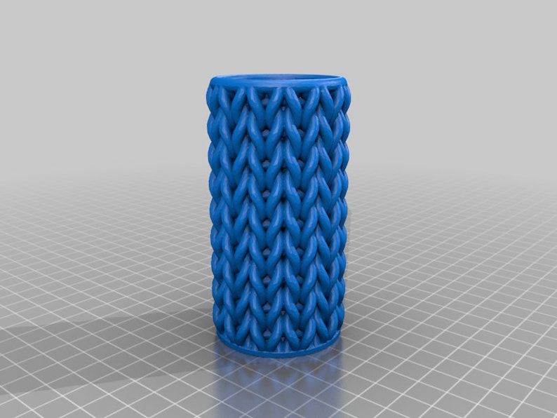 May include: A blue 3D printed cylindrical container with a woven pattern.