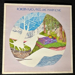 May include: A vintage vinyl record album cover featuring a circular illustration of a bed in a forest setting. The album cover is titled "Roberta Flack / Feel Like Makin' Love".