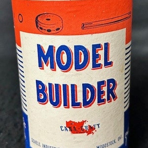 May include: A vintage metal tin with a red, white, and blue label. The label reads "Model Builder" and "Cana Craft" in red letters. The tin is for model building supplies.