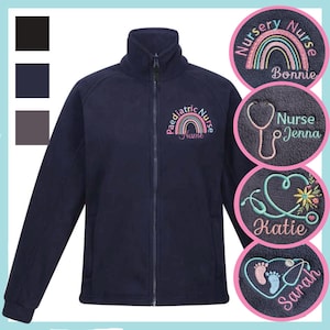 May include: A dark navy blue zip-up fleece jacket featuring an embroidered rainbow design with the text Paediatric Nurse Name. Circular insets display additional embroidery options including a stethoscope, heart, and baby footprints.