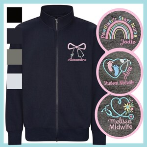 May include: A navy blue zip-up jacket with a high collar and long sleeves. The chest features an embroidered pink stethoscope shaped like a bow with the name Alexandra. Three circular insets show embroidery designs with names and titles.