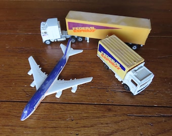 Federal Express Boeing 747 Airplane, Kenworth Road Champs Big Shots die cast metal Semi truck/trailer (HO scale), Matchbox container truck