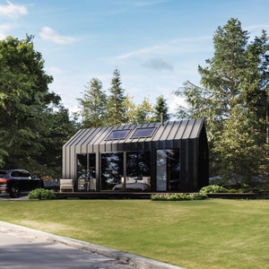 Cabin view showcasing vast sliding glass doors and oversized windows, inviting abundant natural light into the interior. The open layout blurs indoor-outdoor boundaries, fostering a tranquil connection with nature. A contemporary cabin aesthetics