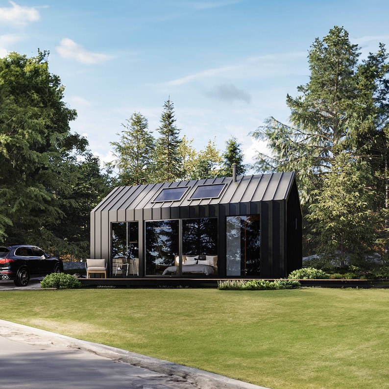 Cabin view showcasing vast sliding glass doors and oversized windows, inviting abundant natural light into the interior. The open layout blurs indoor-outdoor boundaries, fostering a tranquil connection with nature. A contemporary cabin aesthetics