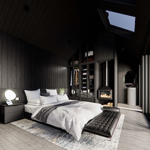 Interior view of a studio cabin featuring a cozy chimney, closet, vanity area, and stylish low-profile bed. Light gray flooring contrasts with dark wood walls. Skylights invite natural light, creating a warm, modern cabin aesthetic.