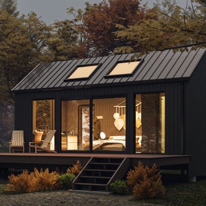 Front view of a cabin with expansive sliding doors and large windows, allowing natural light to illuminate the interior. The open design merges indoor and outdoor spaces, creating a serene, nature-inspired atmosphere in modern cabin living