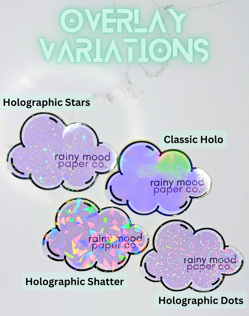 May include: Four cloud-shaped stickers with different holographic finishes. Each sticker features the text "rainy mood paper co."