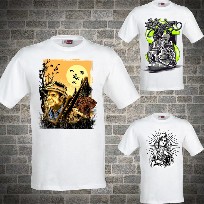 May include: Three white t-shirts with different graphic designs. The first shirt features a hunter with a dog and birds flying overhead. The second shirt features a cartoon character with a dollar sign and graffiti. The third shirt features a woman with a halo and a cross.