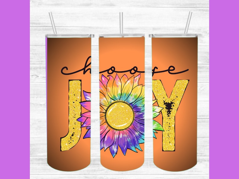 May include: Three orange tumblers with lids and straws. The tumblers have the words "Choose Joy" written on them in black script. The "J" and "Y" are decorated with gold glitter. A colourful tie-dye sunflower is in the centre of the tumblers.