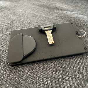 ID card holder with integrated RFID chip holder and fold-out key