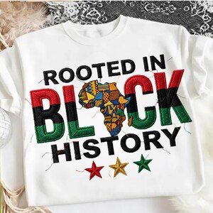 May include: White t-shirt with embroidered text and graphics. The words "ROOTED IN BLACK HISTORY" are stitched in black, red, green, and gold. A colorful map of Africa is in the center, with three stars below.