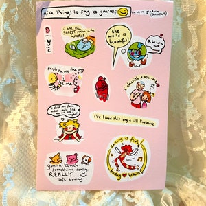 May include: A pink card with colorful illustrations and text. The text includes "nice things to say to yourself" and positive affirmations like "I am the safest person in the world!" and "The world is beautiful!"