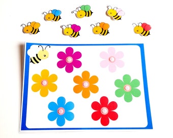 May include: A colorful bee matching game with seven flowers and eight bees. The flowers are pink, red, blue, green, yellow, and orange. The bees are yellow with black stripes.