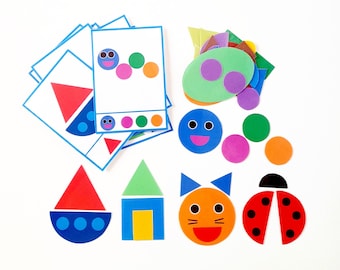 May include: A set of colorful felt shapes for kids to learn about colors and shapes. The set includes a red triangle, a blue circle, a green square, a yellow rectangle, an orange oval, a purple heart, a black ladybug, a red boat, a green house, an orange cat, and a blue caterpillar.