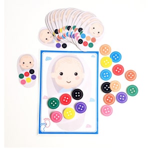 May include: A baby button matching game with a baby face on a card and colorful buttons to match. The game includes a card with a baby face and 16 colorful buttons.