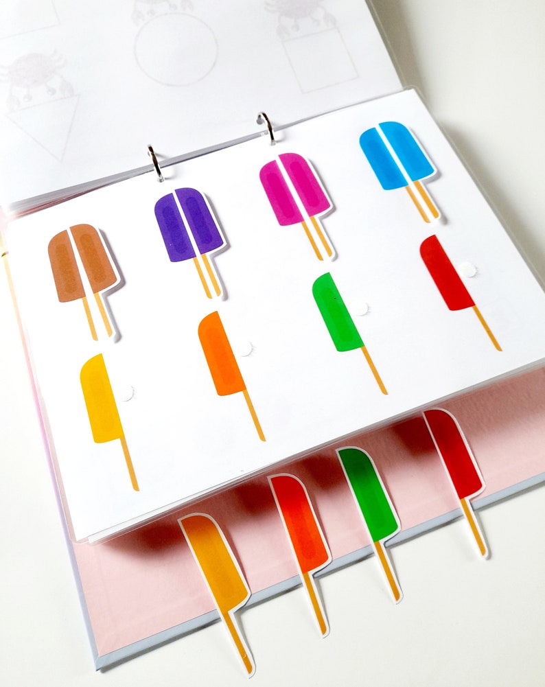 May include: A set of colorful popsicle stickers in various colors, including red, orange, yellow, green, blue, purple, and brown. The stickers are arranged in rows on a white background.