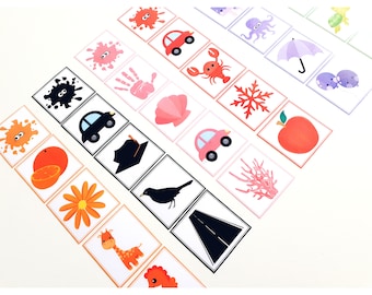 May include: A set of colorful matching cards featuring various images, including a car, a crab, a snowflake, a handprint, a flower, a giraffe, a bird, a road, a seashell, an orange, a paint splatter, an octopus, an umbrella, a turtle, an apple, and coral.