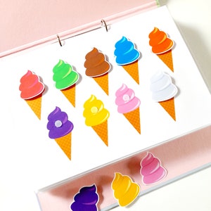 May include: A set of colorful ice cream cone stickers with different colored ice cream scoops. The stickers are arranged in rows on a white background.