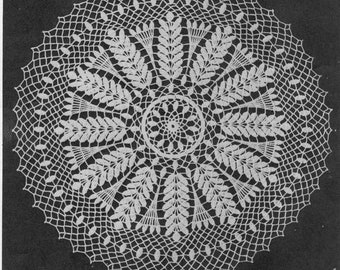 May include: White crochet doily with a delicate floral design. The doily features a central circle with a repeating pattern of leaves and a scalloped edge.