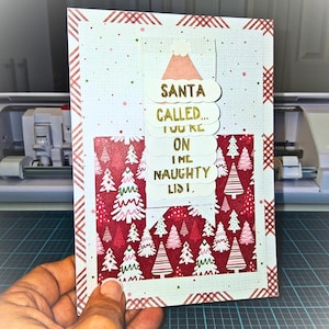 May include: A handmade Christmas card with a red and white patterned border. The card features a layered design with a red and white Christmas tree pattern and the text "SANTA CALLED... YOU'RE ON THE NAUGHTY LIST" in gold lettering.
