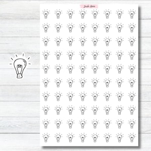 May include: A sheet of 100 white sticker labels with a black outline of a lightbulb on each label. The lightbulb has a simple design with a rounded top and a straight base. The text "Jude Anne" is printed in black at the top of the sheet.