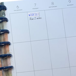 May include: A white planner with a blue sticky note that says "WORKOUT" and "Ran 2 miles" on a page labelled "Friday" in a weekly calendar.
