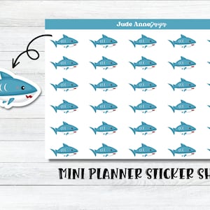 May include: A sheet of planner stickers featuring 36 blue shark illustrations. Each shark has a white belly and a red mouth. The text "MINI PLANNER STICKER SHEET" is printed at the bottom of the sheet.