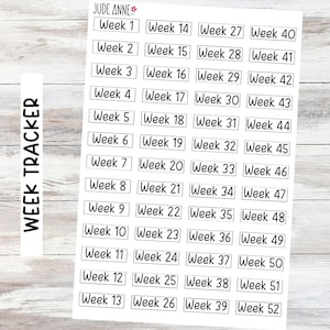May include: A sheet of stickers with the text "Week Tracker" and the name "Jude Anne". The stickers are rectangular and labeled with the weeks of the year, from Week 1 to Week 52, in a black font.