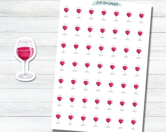 May include: A sticker sheet featuring multiple watercolor illustrations of wine glasses filled with red wine, arranged in a grid pattern. A single, larger die-cut sticker of a wine glass is placed to the left. The text Jude Anne Designs is printed at the top.
