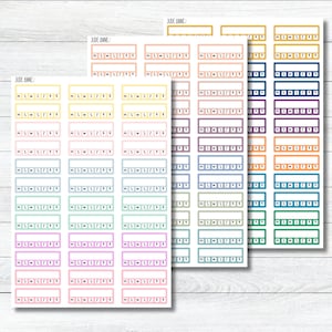 May include: Three sheets of rectangular planner stickers by Jude Anne, each featuring rows of boxes with a blank space above a row of small squares labeled with the letters m, t, w, t, f, s, s. The stickers come in a variety of pastel and bold colors.