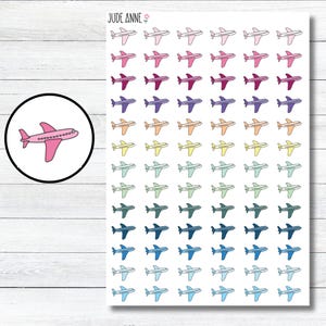 May include: A sheet of 63 colorful airplane stickers. The airplanes are in various shades of pink, purple, blue, green, yellow, and orange. The stickers are perfect for travel journals, planners, and scrapbooks.