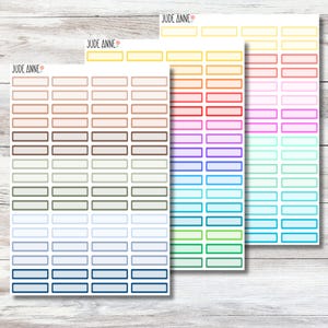May include: Three sheets of planner stickers with rectangular boxes in various colors. The sheets are labeled "Jude Anne" at the top. Colors include shades of brown, blue, green, purple, red, and yellow. Each sheet has multiple rows of boxes.