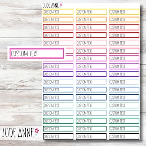 May include: A sheet of colorful planner stickers with the text "JUDE ANNE" at the top and bottom. The stickers are rectangular and have a white border. The text "CUSTOM TEXT" appears on each sticker.