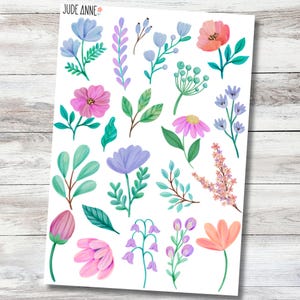 May include: A sheet of floral stickers featuring various colorful flowers and leaves in shades of pink, purple, blue, and green. The stickers include different flower types and foliage, with the text "Jude Anne" in the top left corner.