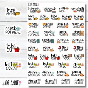 May include: A sheet of planner stickers with various dinner-related themes. The stickers include phrases like "Taco Night," "Crock Pot Meal," and "Take Out," each accompanied by related illustrations. The stickers are white with colorful graphics.