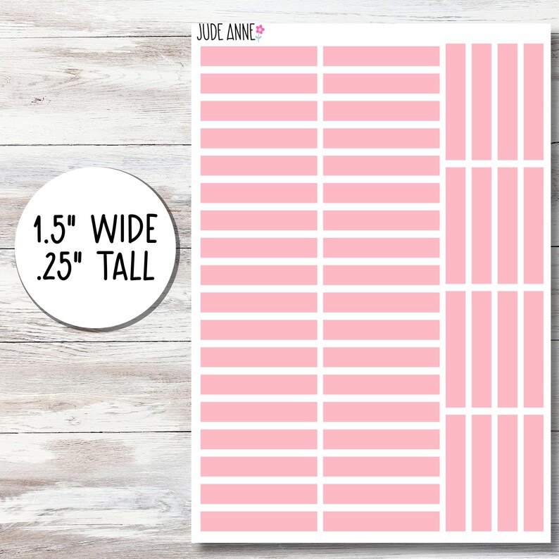 May include: Sheet of pink and white planner stickers. The stickers are rectangular, 1.5 inches wide and .25 inches tall. The sheet also includes vertical pink and white stickers. The brand name "Jude Anne" is in the top right corner.