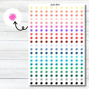 May include: A sheet of colorful flower stickers with a gradient of colors from yellow to black. The stickers are arranged in rows and columns on a white background. The text "Jude Anne" is printed at the top of the sheet.