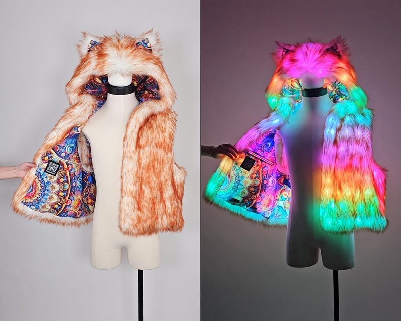 May include: A sleeveless faux fur vest with an attached hood featuring animal ears. The exterior is orange and white, while the interior lining displays a colorful, intricate mandala pattern. The vest includes integrated LED lights.