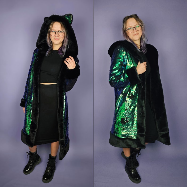 May include: A long black and green sequined coat with a faux fur trim and a hood. The hood has cat ears.
