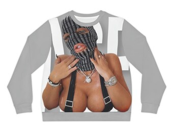 May include: Gray sweatshirt featuring a graphic of a person wearing a black and silver striped balaclava. The person is wearing a black top with suspenders and jewelry. The word "NET" is printed in white on the sweatshirt.