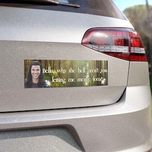 May include: Rectangular bumper sticker with a photo of a man and text that reads, "Bella, why the hell aren't you letting me merge loca?" The background is a forest scene.