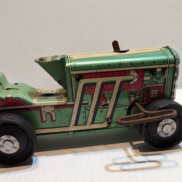 Vintage Marx 8.5" wind up tractor tin litho toy.  Missing driver and exhaust plastic piece, but the wind-up key works and tractor moves.