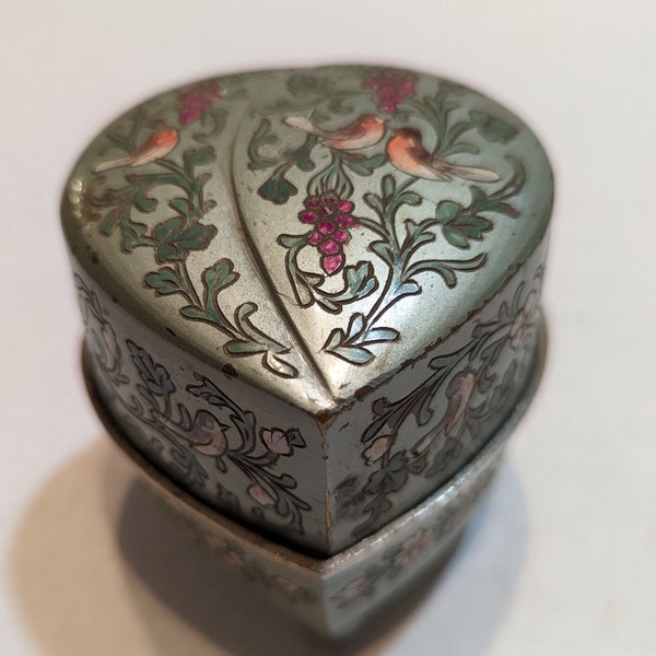 Beautiful vintage heart shaped, silver ornate design, music trinket box.  Blue velvet inside, very heavy, with some chipping of paint.