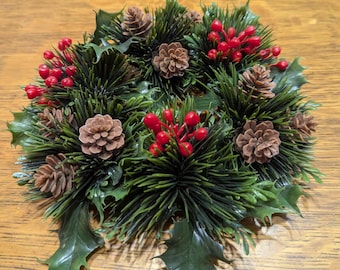 Vintage plastic candle ring, 9" diameter.  Candle ring consists of pine needles, pinecones, hollyberries with leaves. Great holiday floral.