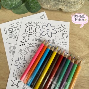 May include: Two black and white coloring pages with positive affirmations and doodles. The pages are next to a pack of ten colored pencils in a clear plastic bag.