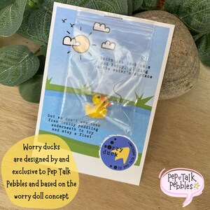May include: A yellow rubber duck in a clear plastic bag with a blue background. The duck is floating on water. The text on the card reads "Ducks can look calm and happy, gliding on the water's surface, but we don't see them frantically paddling underneath to try and stay afloat."  The text on the sticker reads "worry duck".