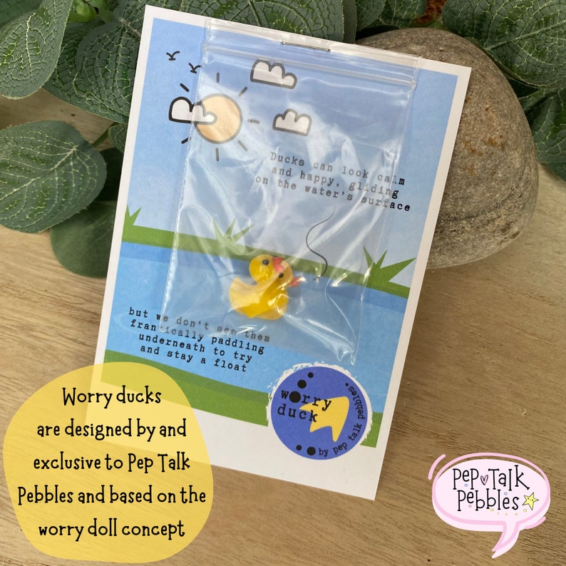 May include: A yellow rubber duck in a clear plastic bag with a blue background. The duck is floating on water. The text on the card reads "Ducks can look calm and happy, gliding on the water's surface, but we don't see them frantically paddling underneath to try and stay afloat."  The text on the sticker reads "worry duck".