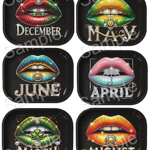 May include: Six black rolling trays with colorful lips designs, each representing a month: December, May, June, April, March, and August. The lips are adorned with gemstones and seasonal symbols like a holly sprig, flower, umbrella, shamrock, and sun.