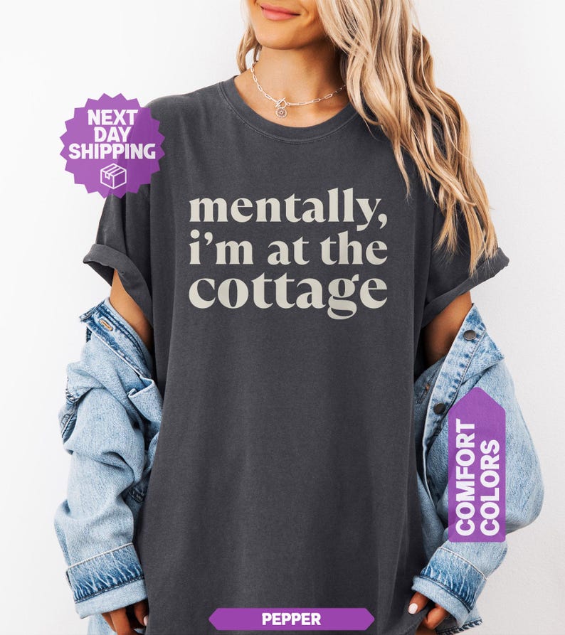 Dark heathered unisex tee with retro serif text reading mentally im at the cottage — funny lake life graphic shirt