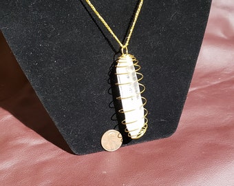 3 1/4 inch clear quartz point in gold cage